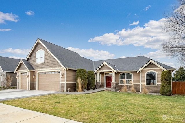 craftsman house featuring a garage and a front yard