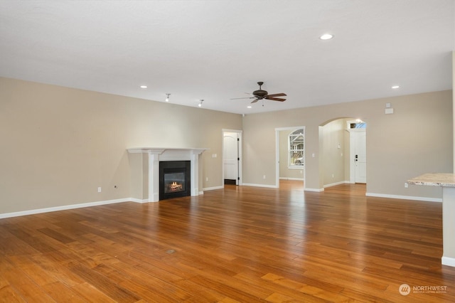 unfurnished living room with hardwood / wood-style floors and ceiling fan