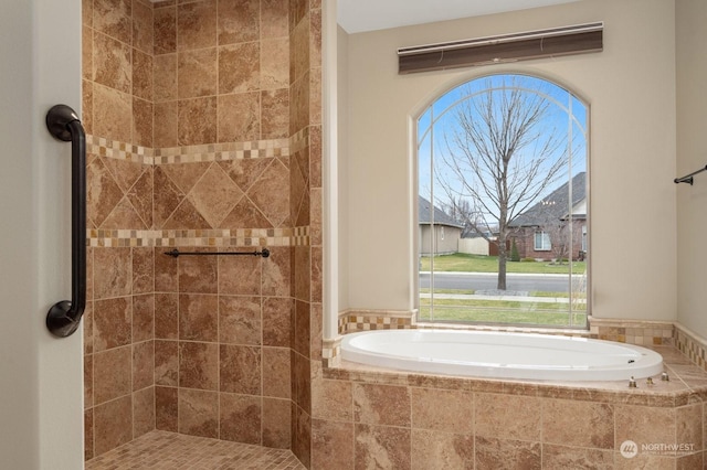 bathroom featuring a relaxing tiled tub