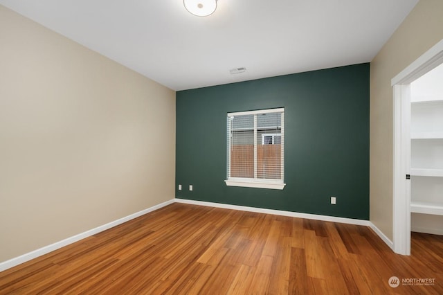 spare room with wood-type flooring