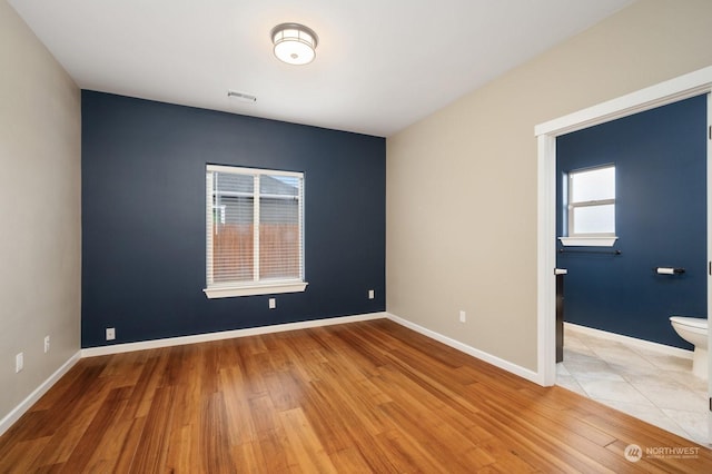 empty room with hardwood / wood-style flooring