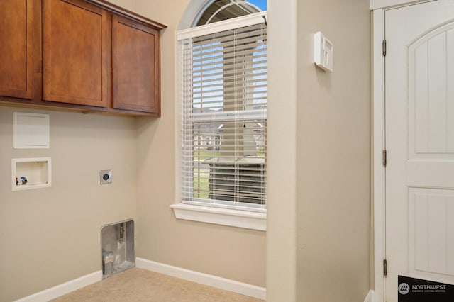 laundry area featuring cabinets, plenty of natural light, hookup for a washing machine, and hookup for an electric dryer