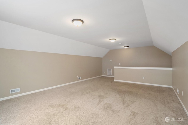 bonus room with lofted ceiling and carpet