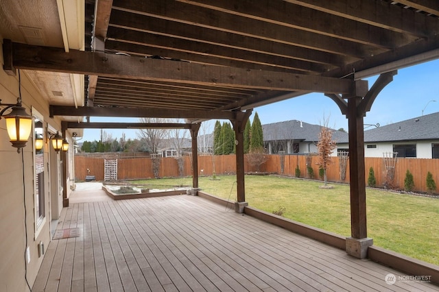 wooden deck featuring a lawn