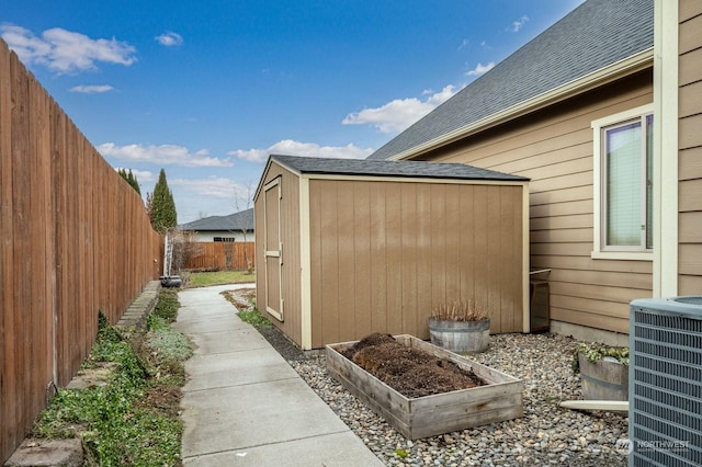 view of side of home featuring central AC and a storage unit