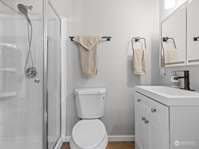 bathroom with vanity, wood-type flooring, an enclosed shower, and toilet