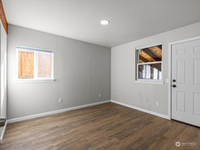spare room with dark hardwood / wood-style flooring