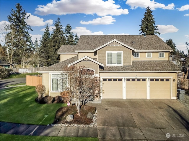 traditional home with a front yard, fence, roof with shingles, an attached garage, and concrete driveway