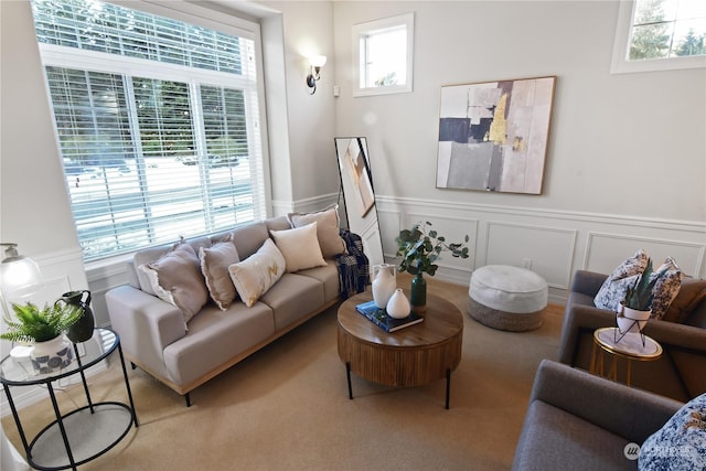 living room featuring carpet floors and wainscoting