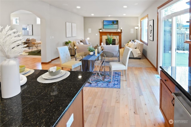 living room with light hardwood / wood-style flooring and a tile fireplace