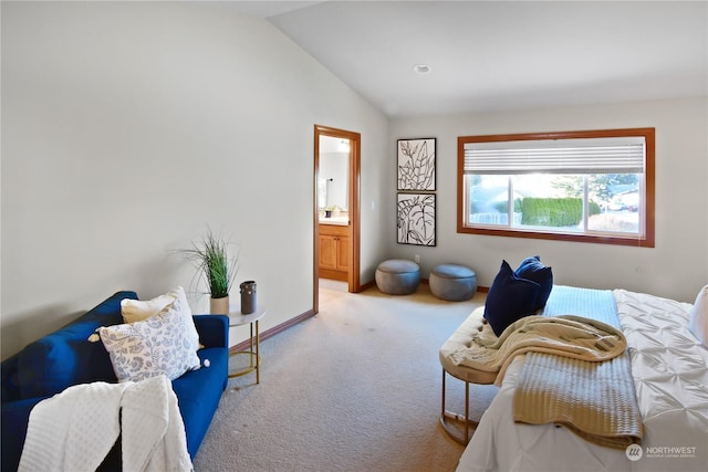 bedroom featuring connected bathroom, carpet flooring, and vaulted ceiling