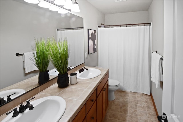 bathroom with vanity, tile patterned floors, and toilet