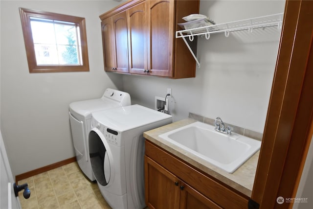 laundry room featuring cabinets, washer and dryer, and sink