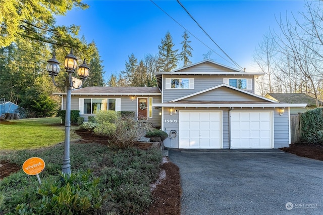 view of front of property featuring a garage and a front lawn