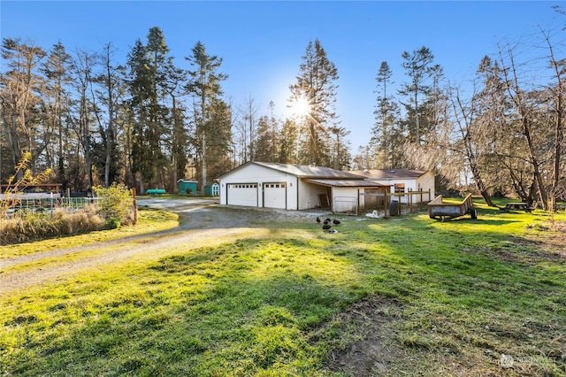 view of side of home featuring a garage and a yard