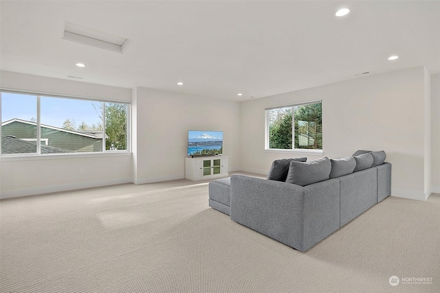 living room featuring light carpet, baseboards, and recessed lighting