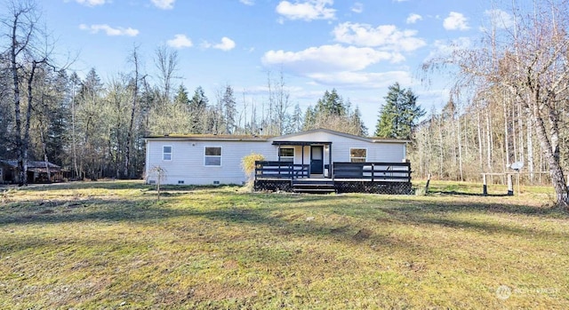 back of house with a yard and a deck