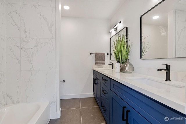 bathroom featuring vanity, a washtub, and tile patterned floors