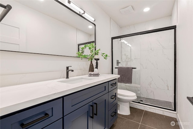 bathroom with tile patterned floors, vanity, toilet, and a shower with shower door