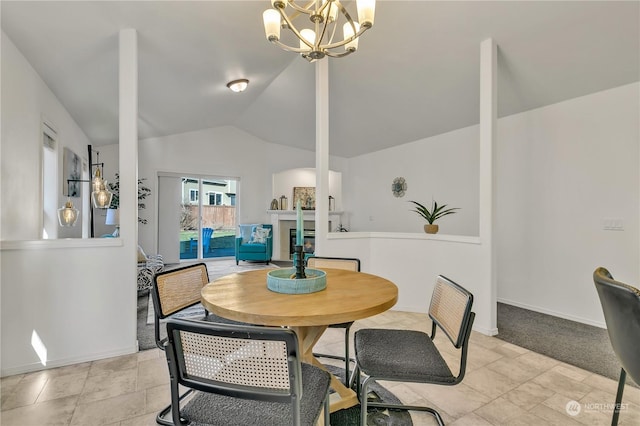 dining space featuring lofted ceiling and an inviting chandelier