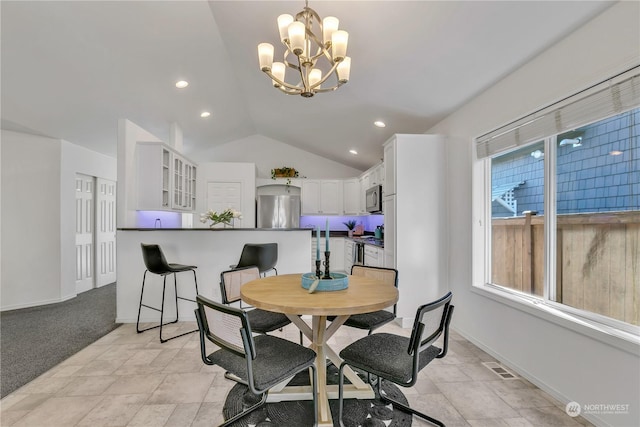 dining space featuring a chandelier and vaulted ceiling