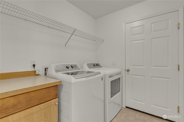 clothes washing area featuring separate washer and dryer