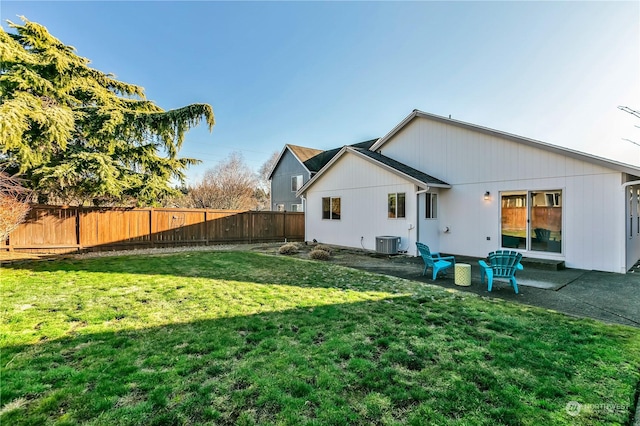 back of property featuring central AC, a patio, and a lawn