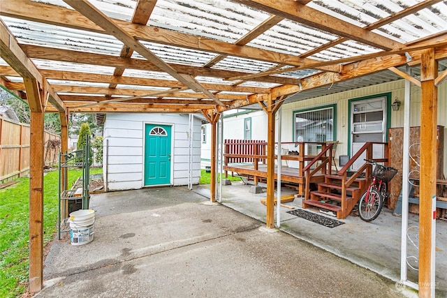 view of patio with a wooden deck and an outbuilding