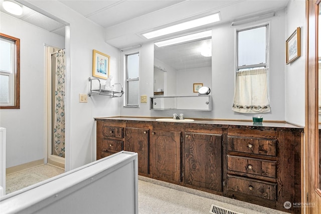 bathroom featuring vanity and curtained shower