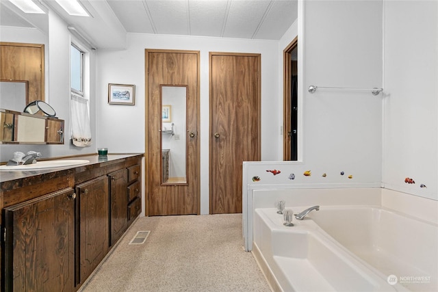 bathroom featuring vanity and a tub to relax in