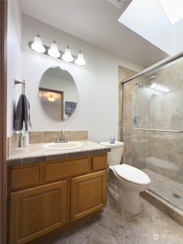 bathroom with an enclosed shower, vanity, and toilet