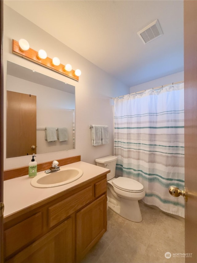 bathroom with tile patterned flooring, vanity, a shower with curtain, and toilet