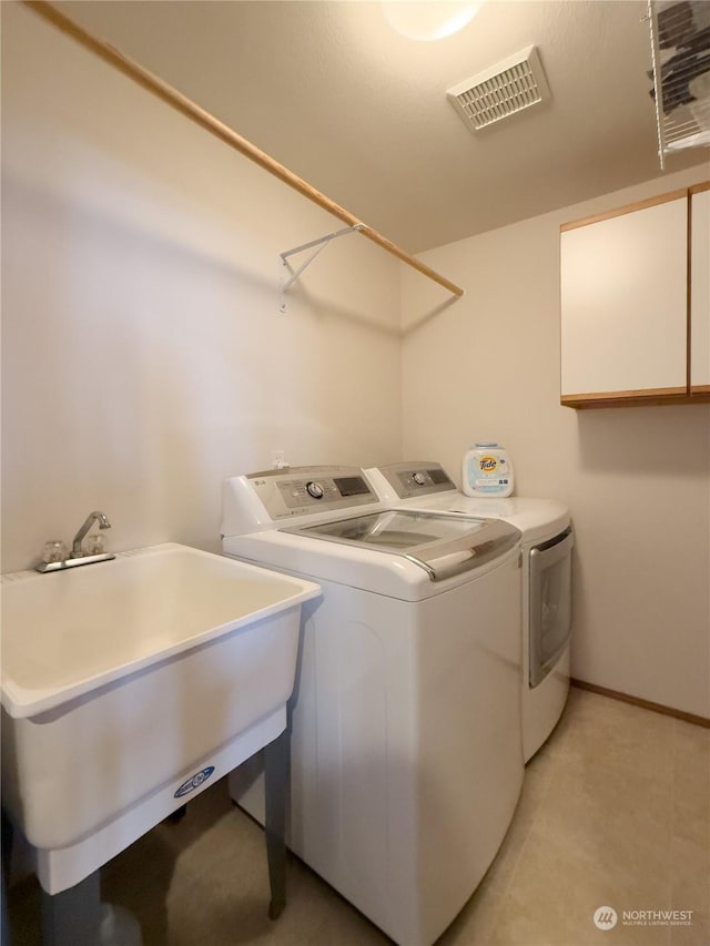 washroom featuring independent washer and dryer and sink