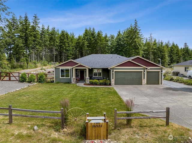 craftsman house featuring a garage and a front lawn