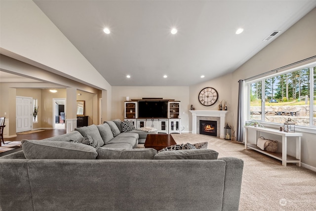 carpeted living room featuring vaulted ceiling