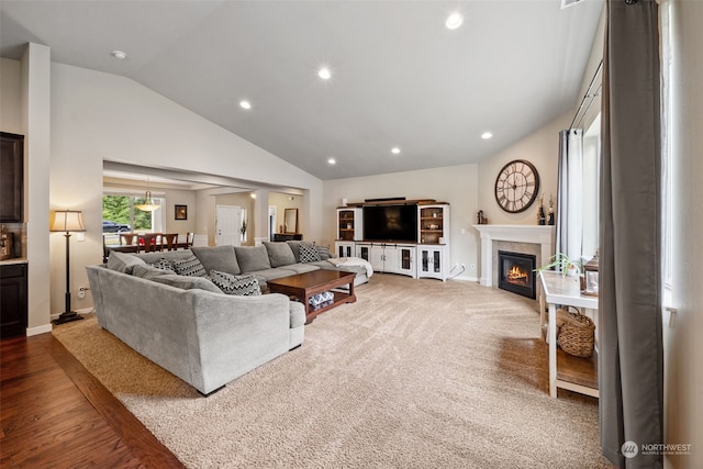 living room featuring hardwood / wood-style flooring and vaulted ceiling