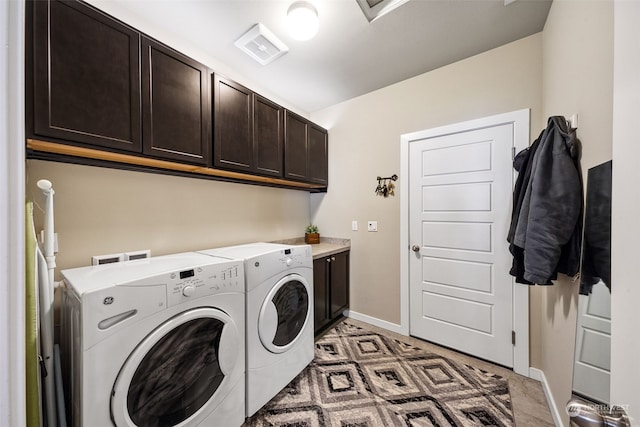 laundry area featuring cabinets and washer and dryer