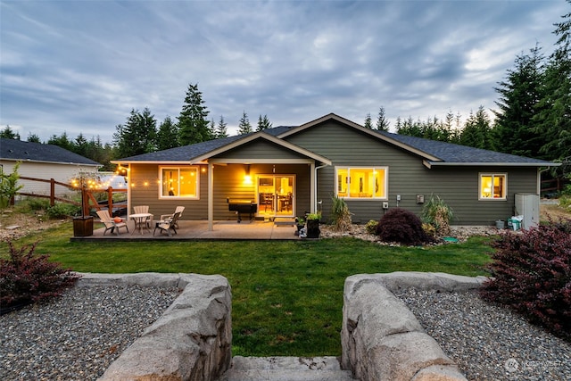 back of property featuring a yard and a patio area