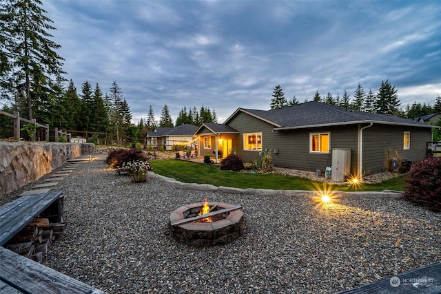 back of house featuring a fire pit