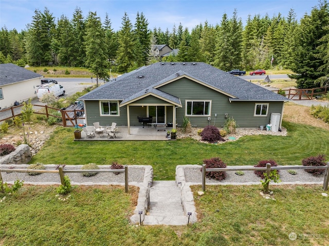 back of house featuring a yard and a patio area