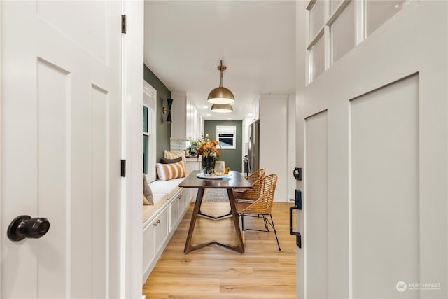 dining area with breakfast area and light wood-type flooring