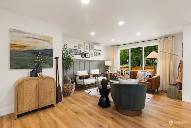 living room with a wall mounted air conditioner and wood-type flooring