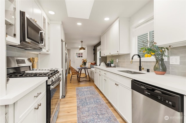 kitchen featuring white cabinetry, stainless steel appliances, and sink