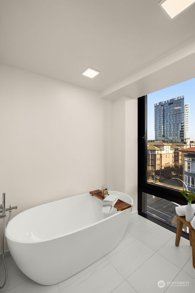 bathroom featuring a washtub and tile patterned floors