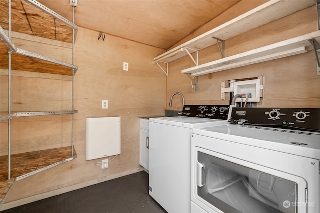 laundry room featuring cabinets and washing machine and clothes dryer