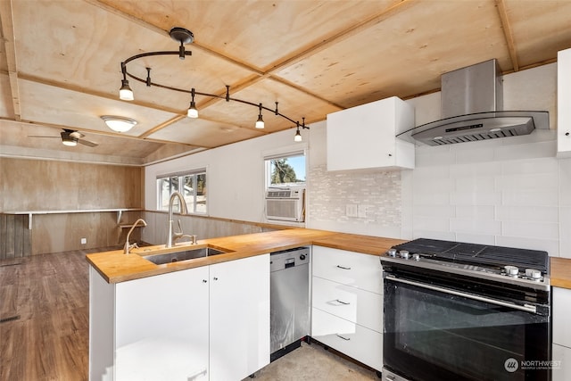 kitchen featuring range with gas stovetop, butcher block countertops, range hood, white cabinets, and stainless steel dishwasher