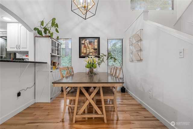 dining room featuring an inviting chandelier, light hardwood / wood-style floors, and a wealth of natural light