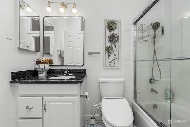 full bathroom featuring tile patterned flooring, enclosed tub / shower combo, vanity, and toilet