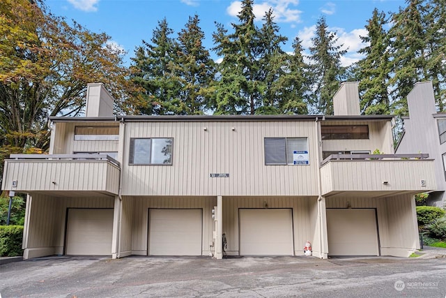 townhome / multi-family property with a garage and a balcony