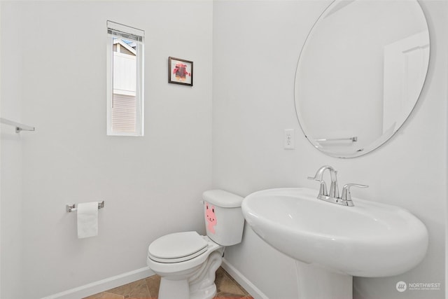 bathroom with tile patterned flooring, sink, and toilet